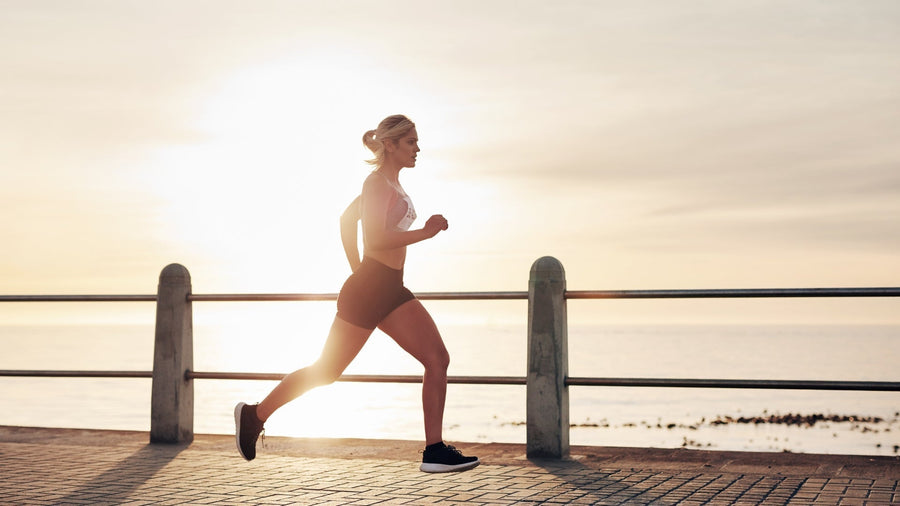 Can High-Impact Activity Permanently Change Your Breasts? Blog by Tigers Eye showing a woman running alongside a sunny seafront