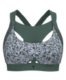 The Tigers Eye sports bra in a jungle green colour and white floral print on the front; front view showing the combination type bra with a patented upper bust compression element which sits in between breasts and widens towards the straps, providing high neckline coverage and upper bust support