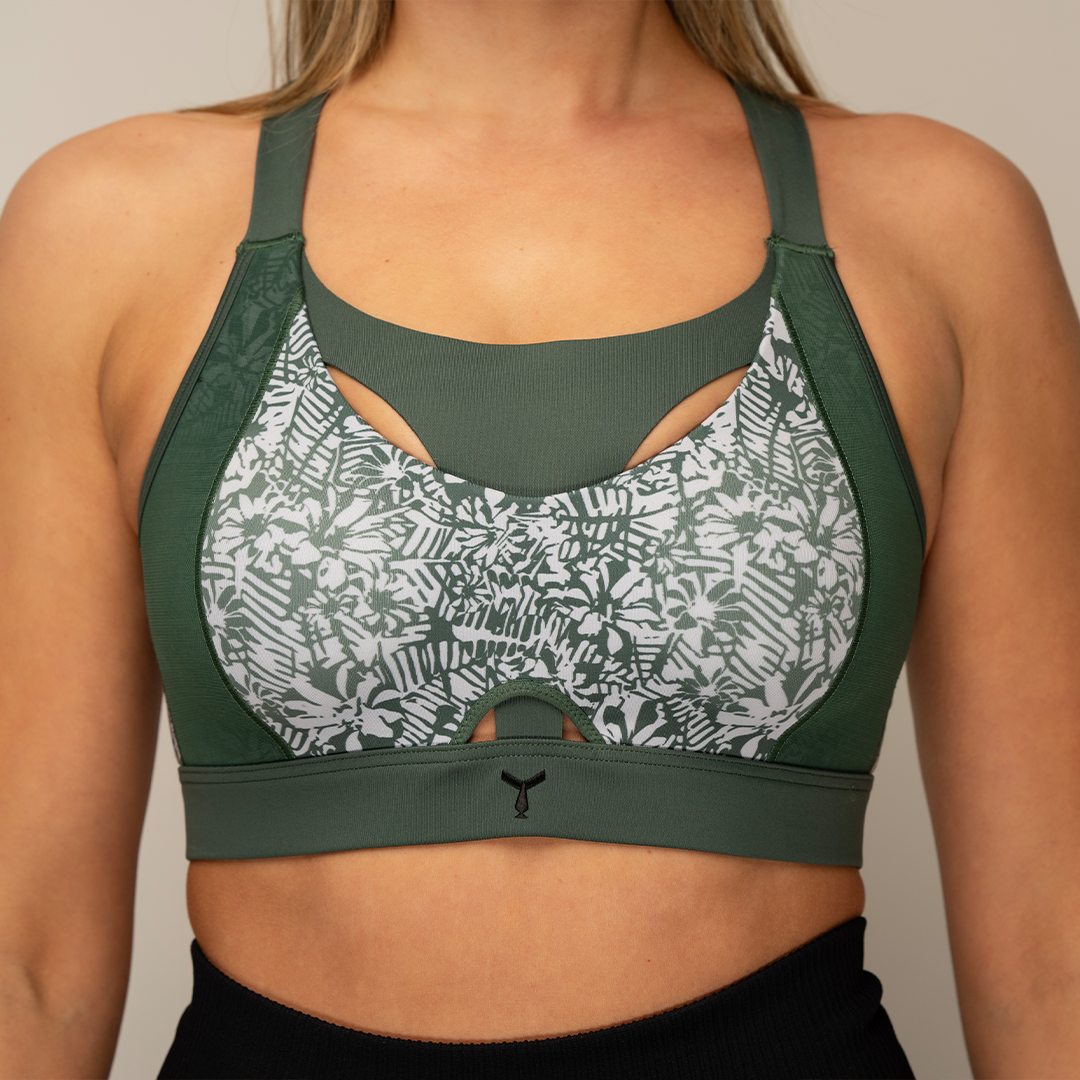 Close-up of the Tigers Eye Jungle sports bra on a model, highlighting the moulded cups and The Vault feature for high support and reduced vertical movement during intense workouts.