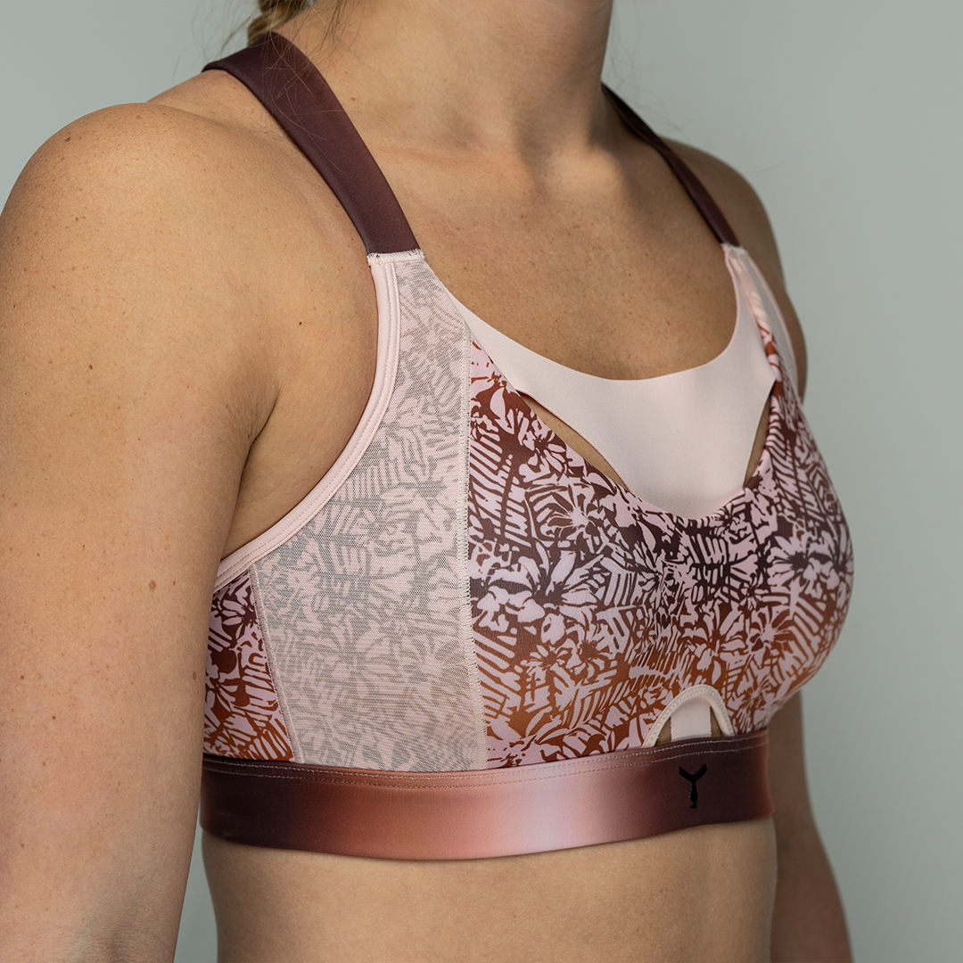 Close-up of the Tigers Eye Orchid sports bra on a model, highlighting the breathable mesh panel on the side and the seamless coverage from the moulded cup for maximum comfort and support.