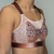 Close-up of Orchid on a model, highlighting the breathable mesh panel on the side of the breast and the seamless coverage provided by the moulded cup. 